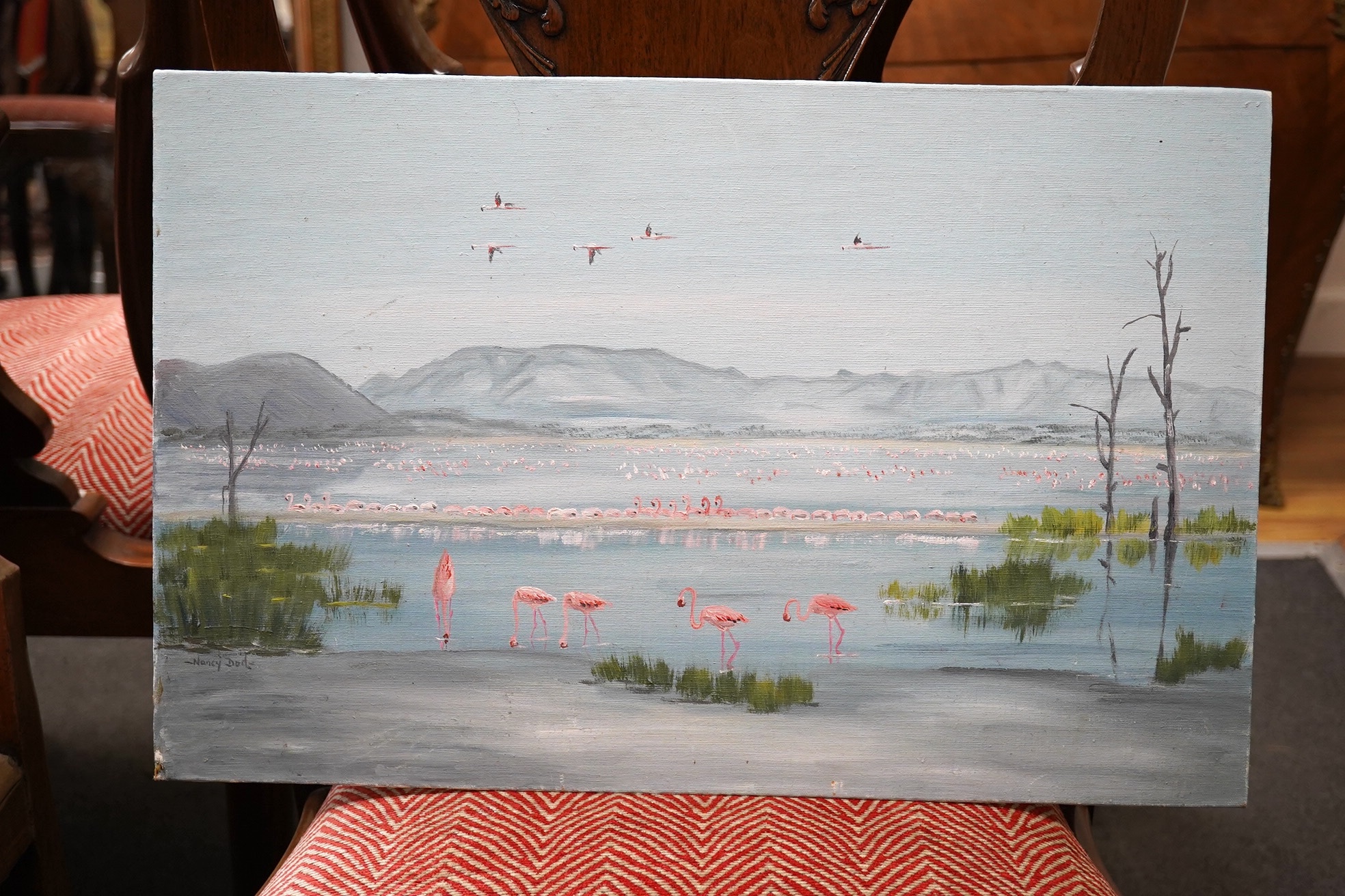 Nancy Dod, oil on canvas board, Mountainous lakeside landscape with flamingos, 33 x 51cm. Condition - fair, would benefit from a clean